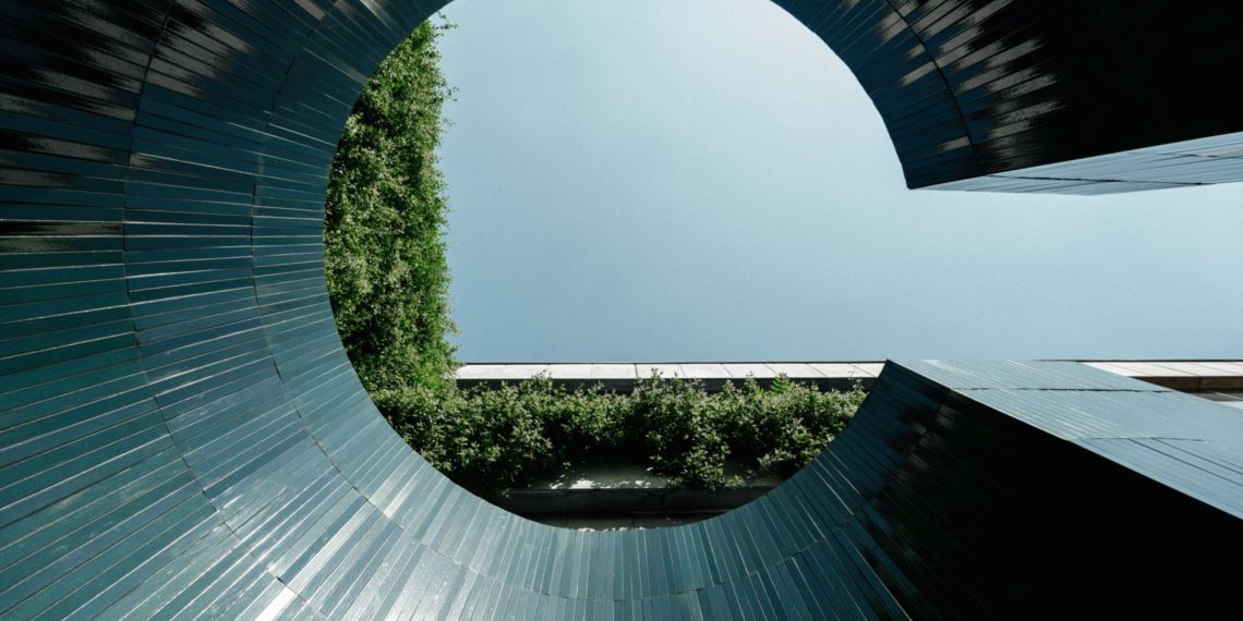 Ranieri lava stone architectural facade — circular form clad in glazed blue-grey tiles